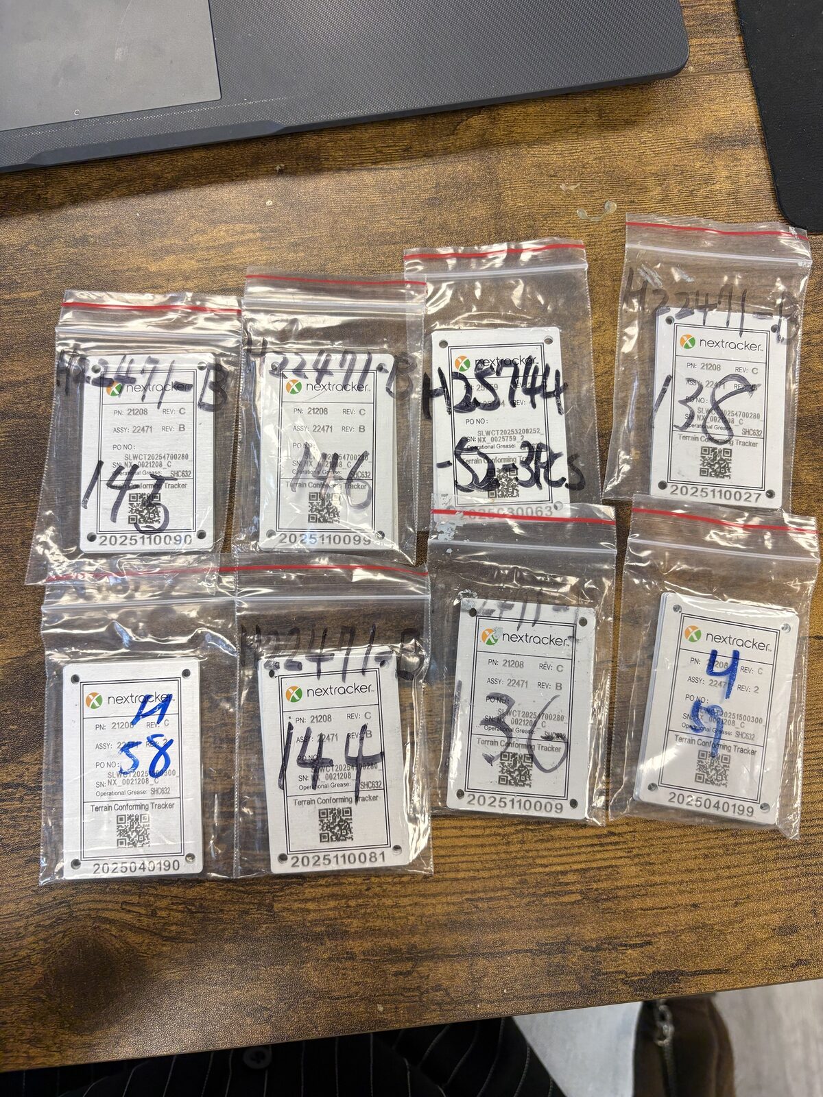 Handwritten crate labels on bags with inconsistent handwriting and crossed-out numbers